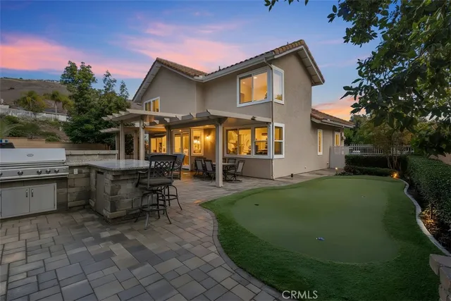 a view of a house with backyard sitting area and garden