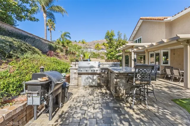 a view of a patio with table and chairs and potted plants