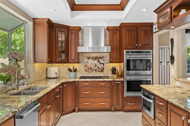 a kitchen with stainless steel appliances granite countertop a stove sink and cabinets