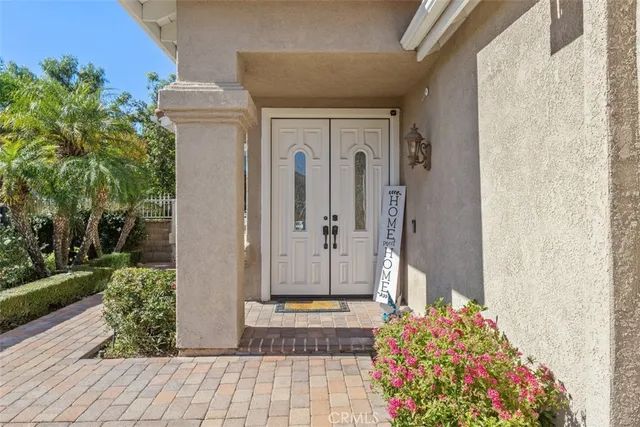 a front view of a house with a potted plant
