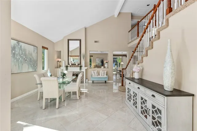 a dining room with furniture entryway and wooden floor
