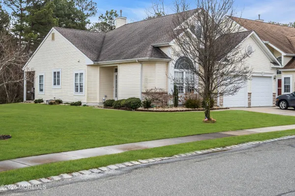 a front view of house with yard and green space