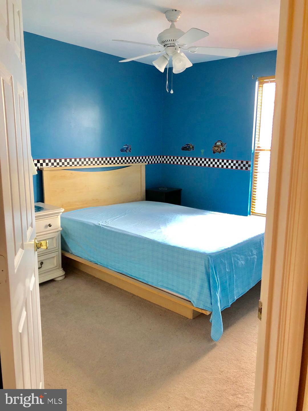4412 Silver Teal Road Baltimore, MD 21236 - Photo 22 of 34 a bedroom with a bed and a chandelier