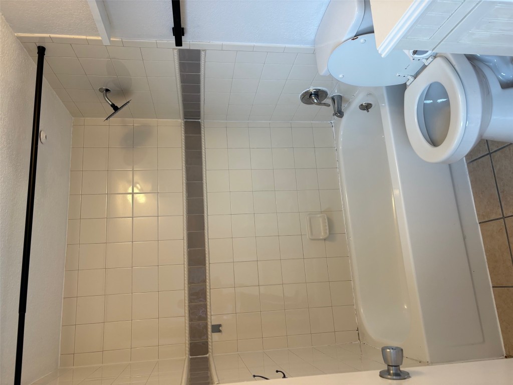 701 Nelray Boulevard, Unit 4 Austin, TX 78751 - Photo 9 of 10 a white toilet sitting next to a bath tub