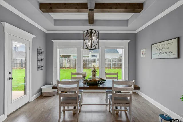 a kitchen with kitchen island a stove a sink dishwasher and a refrigerator with wooden floor