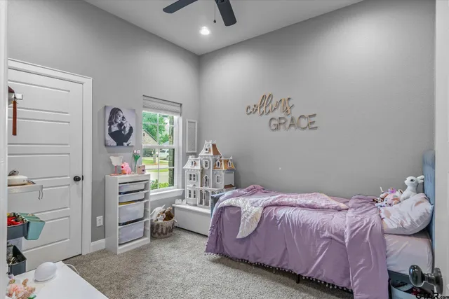 a view of a chair and table in the back yard of the house