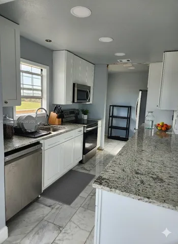 a kitchen with a sink stove and refrigerator