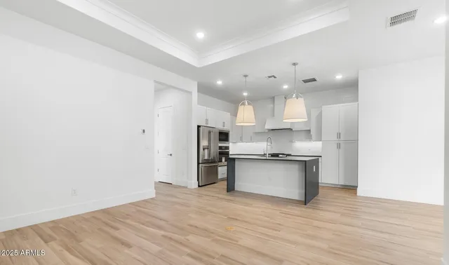 a kitchen with stainless steel appliances granite countertop a refrigerator and a sink
