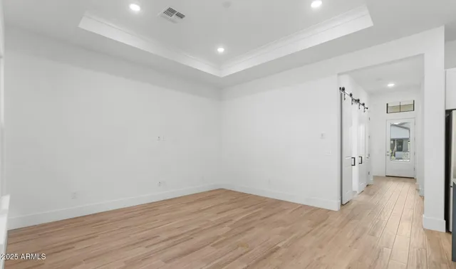 a view of a room with wooden floor and a sink