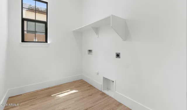 a view of a small space with wooden floor and entryway