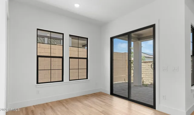 an empty room with windows and closet