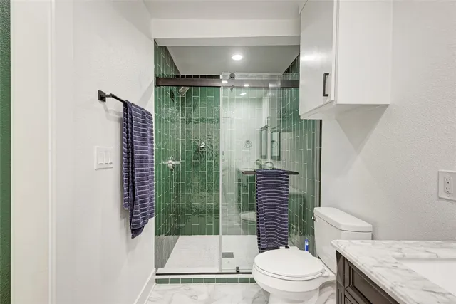 a bathroom with a toilet and a shower