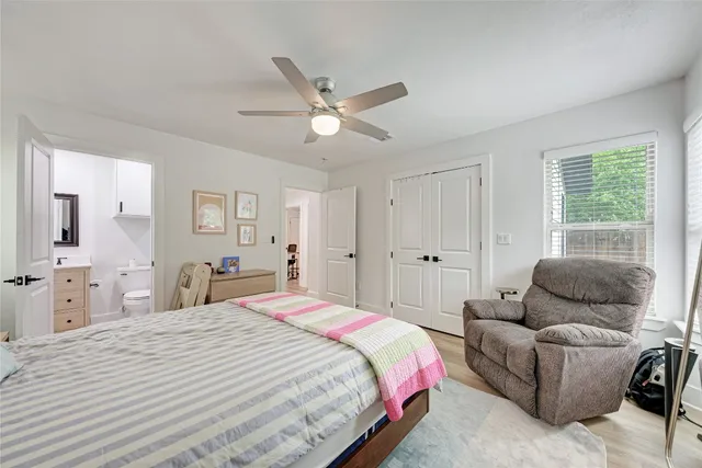 a bedroom with a bed and ceiling fan