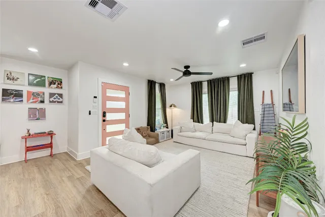 a living room with furniture and large window