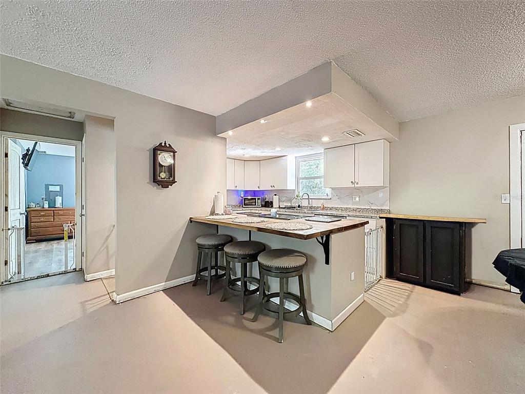 24350 Lanark Road Brooksville, FL 34601 - Photo 11 of 56 a kitchen with a sink cabinets and wooden floor