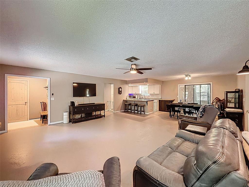 24350 Lanark Road Brooksville, FL 34601 - Photo 12 of 56 a living room with furniture and a flat screen tv