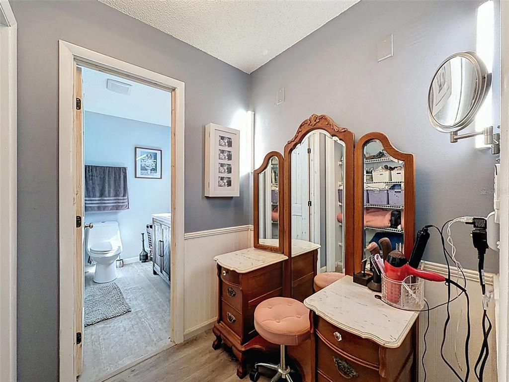 24350 Lanark Road Brooksville, FL 34601 - Photo 18 of 56 a living room with furniture a table and wooden floor