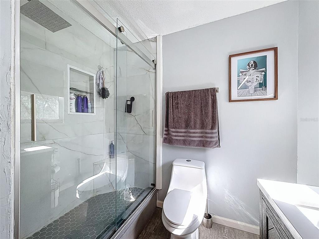 24350 Lanark Road Brooksville, FL 34601 - Photo 20 of 56 a white toilet sitting next to a bathroom sink