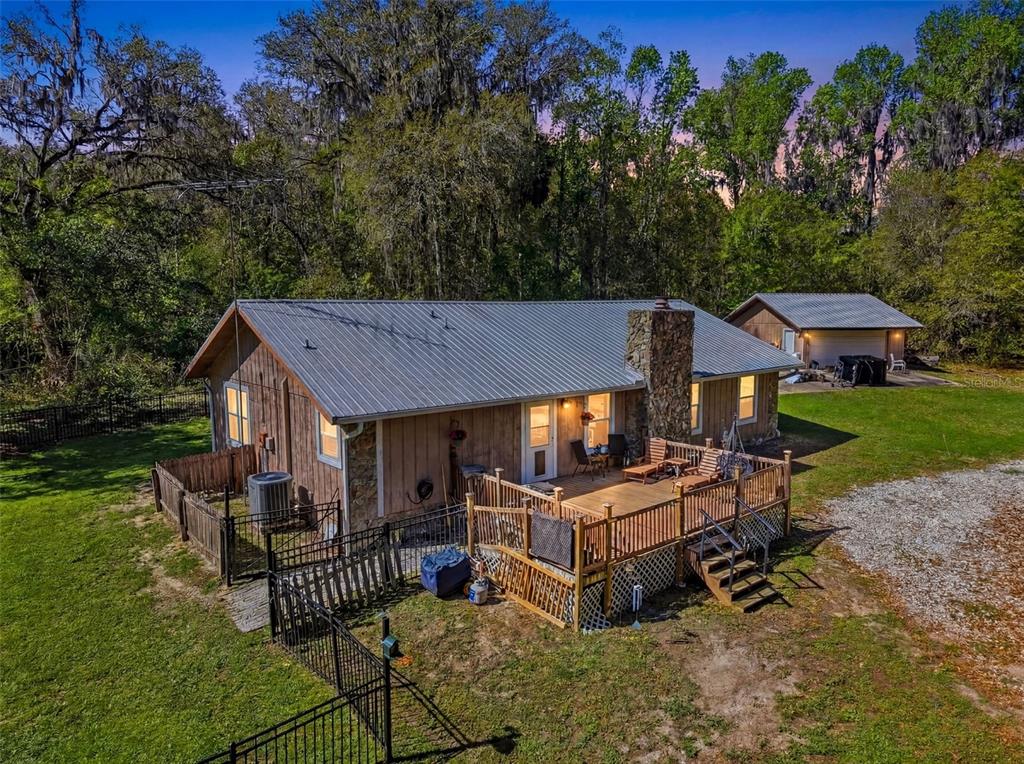 24350 Lanark Road Brooksville, FL 34601 - Photo 2 of 56 a view of a house with backyard and sitting area