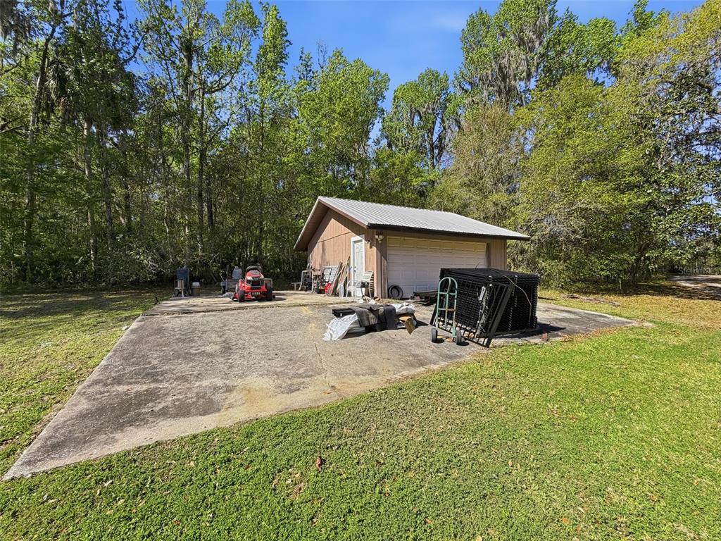 24350 Lanark Road Brooksville, FL 34601 - Photo 30 of 56 a view of a house with backyard and sitting area