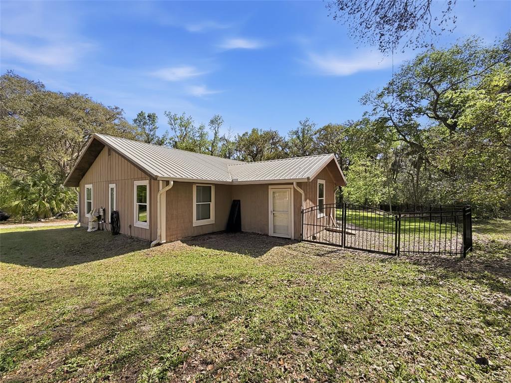 24350 Lanark Road Brooksville, FL 34601 - Photo 41 of 56 a view of a house with a yard