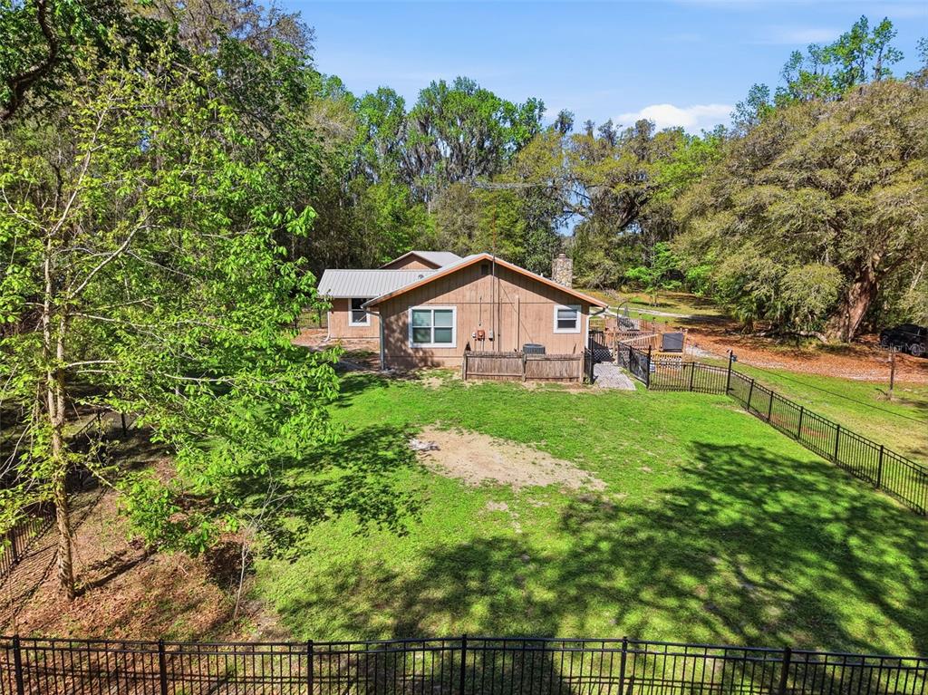24350 Lanark Road Brooksville, FL 34601 - Photo 43 of 56 a view of house with backyard and garden