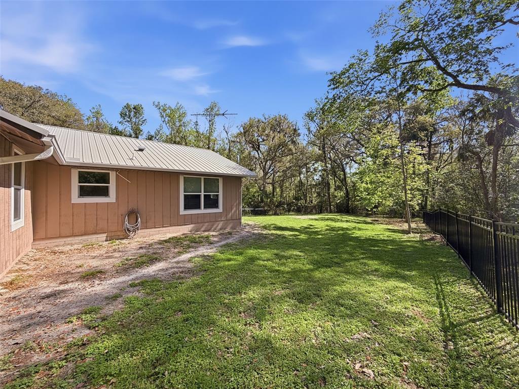 24350 Lanark Road Brooksville, FL 34601 - Photo 45 of 56 a view of a yard in front of a house with large trees