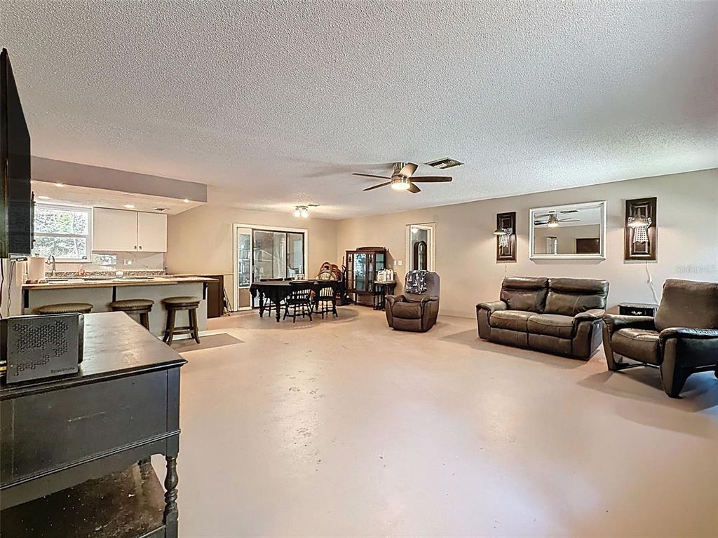 24350 Lanark Road Brooksville, FL 34601 - Photo 6 of 56 a living room with furniture and a flat screen tv