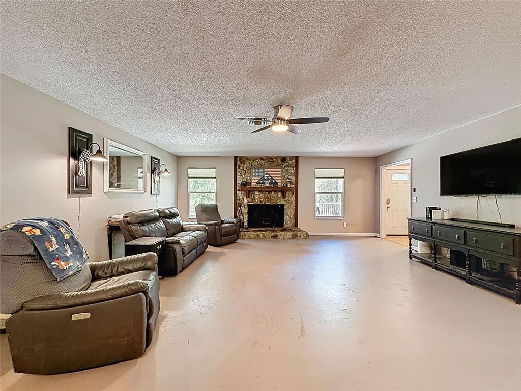 24350 Lanark Road Brooksville, FL 34601 - Photo 7 of 56 a living room with furniture and a flat screen tv