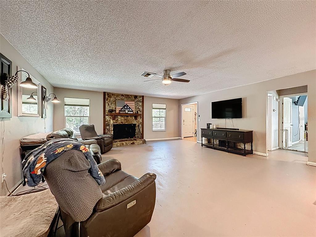 24350 Lanark Road Brooksville, FL 34601 - Photo 8 of 56 a living room with furniture and a flat screen tv