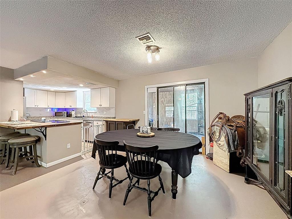 24350 Lanark Road Brooksville, FL 34601 - Photo 9 of 56 a kitchen with a table and chairs in it