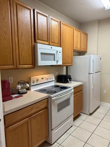 a kitchen with a stove microwave and refrigerator
