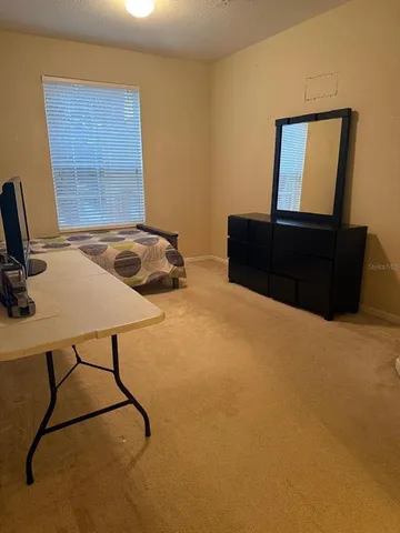 a bedroom with a bed and window