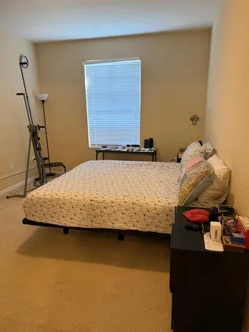 a bedroom with a bed and dresser