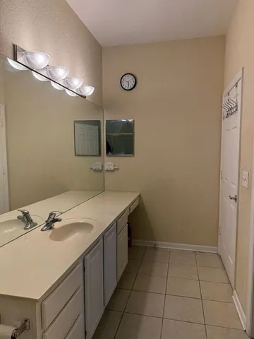a bathroom with a sink vanity and a mirror