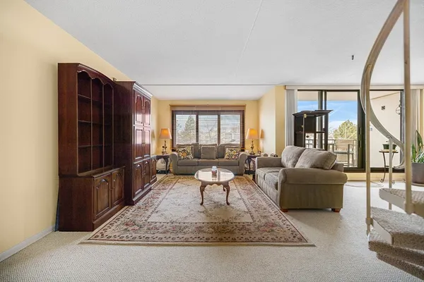 a living room with furniture and a chandelier