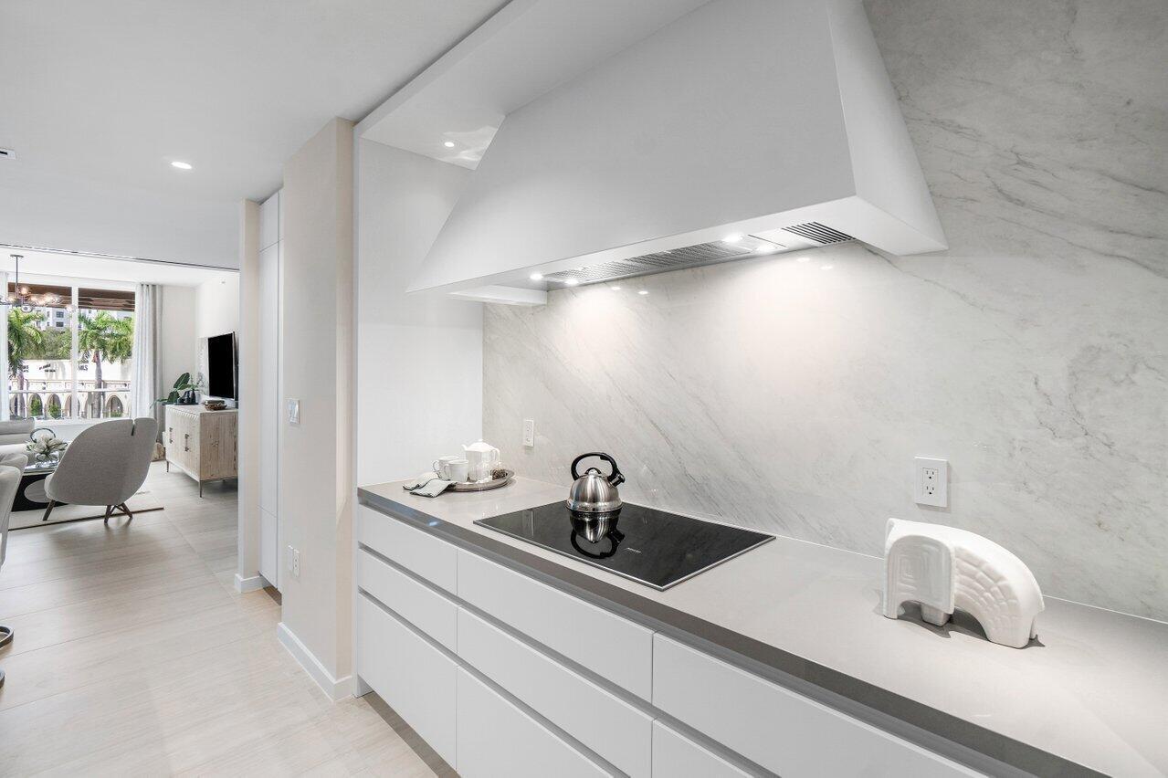 200 Southeast Mizner Boulevard, Unit 211 Boca Raton, FL 33432 - Photo 9 of 67 a kitchen with a sink and living room