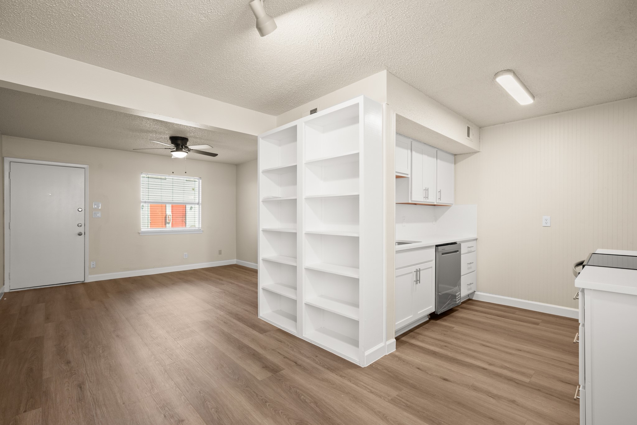 2408 Longview Street, Unit 112 Austin, TX 78705 - Photo 4 of 15 a view of an empty room with a window and wooden floor