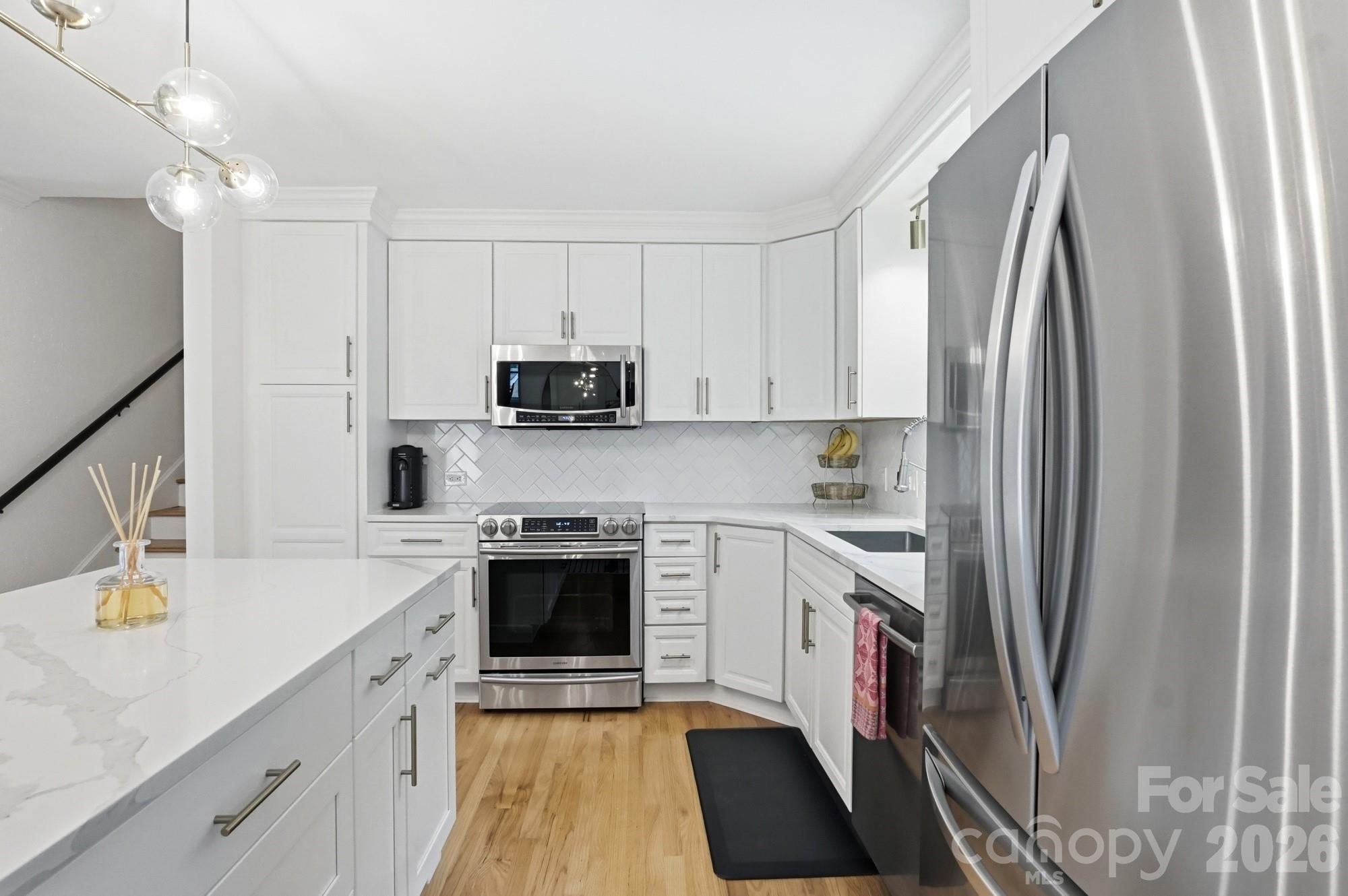 824 Riverwood Road Charlotte, NC 28270 - Photo 6 of 37 a kitchen with stainless steel appliances a stove sink and refrigerator