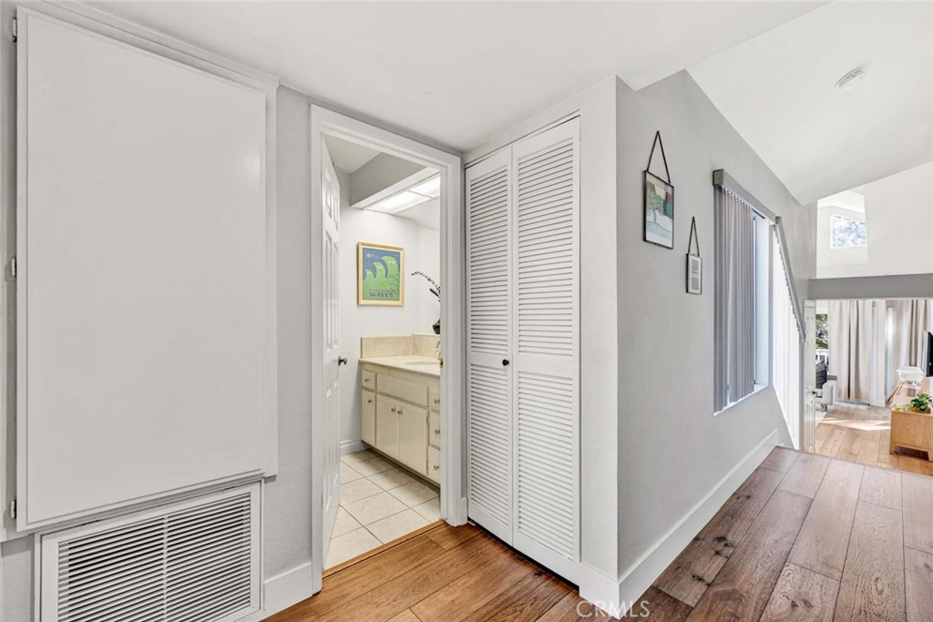 789 Grayling Bay Costa Mesa, CA 92626 - Photo 14 of 42 a view of a hallway with bathroom and wooden floor