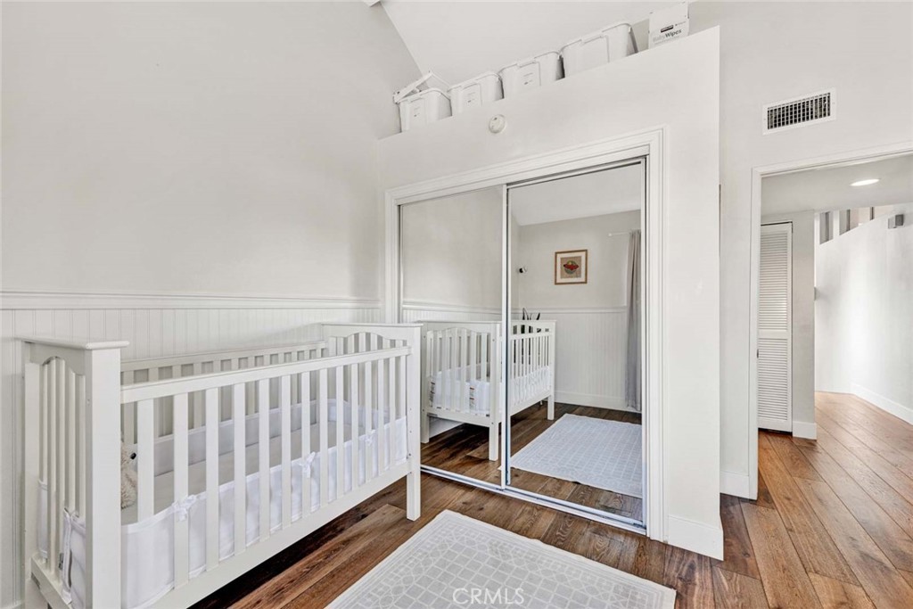 789 Grayling Bay Costa Mesa, CA 92626 - Photo 17 of 42 a view of a hallway with wooden floor and windows