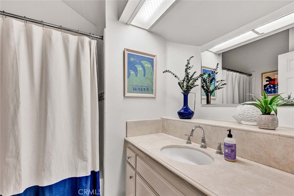 789 Grayling Bay Costa Mesa, CA 92626 - Photo 18 of 42 a bathroom with a sink a mirror and a potted plant