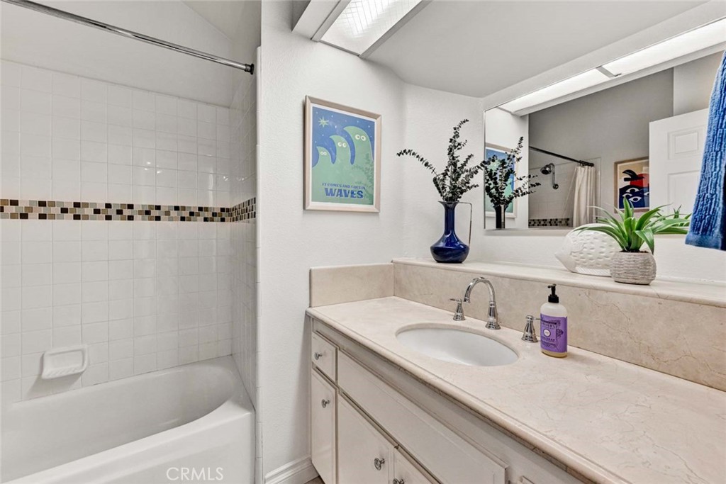 789 Grayling Bay Costa Mesa, CA 92626 - Photo 19 of 42 a bathroom with a granite countertop sink a mirror and a shower
