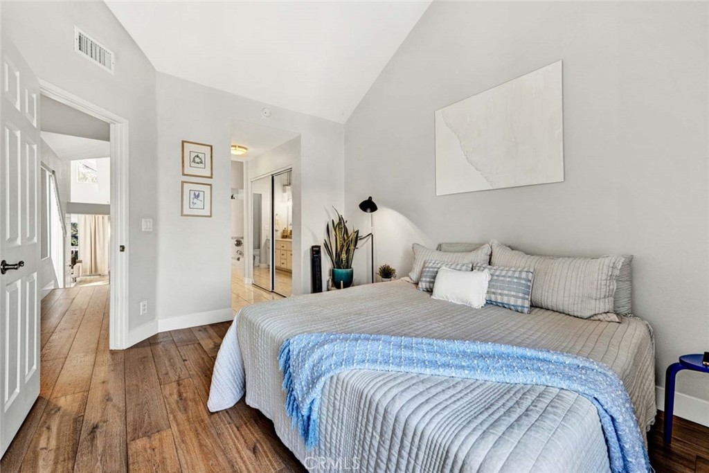 789 Grayling Bay Costa Mesa, CA 92626 - Photo 22 of 42 a bedroom with a bed and a wooden floor