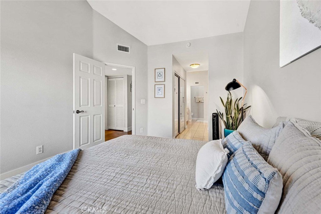 789 Grayling Bay Costa Mesa, CA 92626 - Photo 23 of 42 a bedroom with a bed and a chandelier