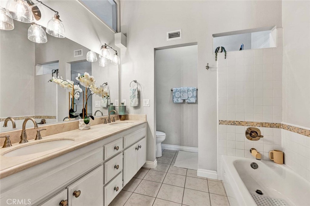 789 Grayling Bay Costa Mesa, CA 92626 - Photo 25 of 42 a spacious bathroom with a tub sink mirror and shower