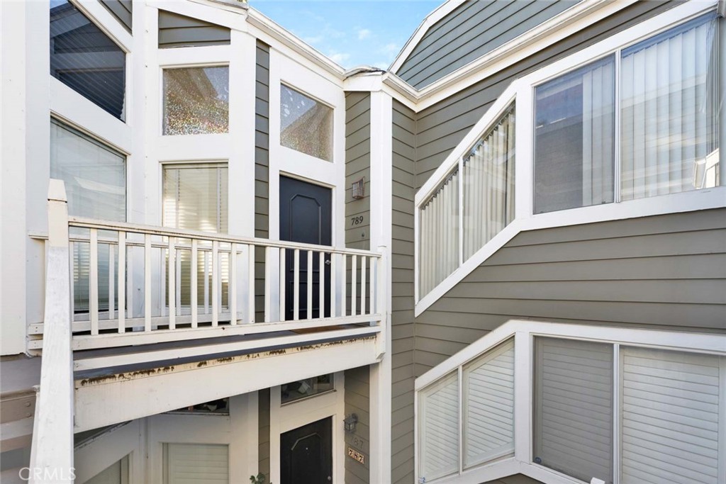789 Grayling Bay Costa Mesa, CA 92626 - Photo 3 of 42 a view of wooden balcony with a large window and stairs
