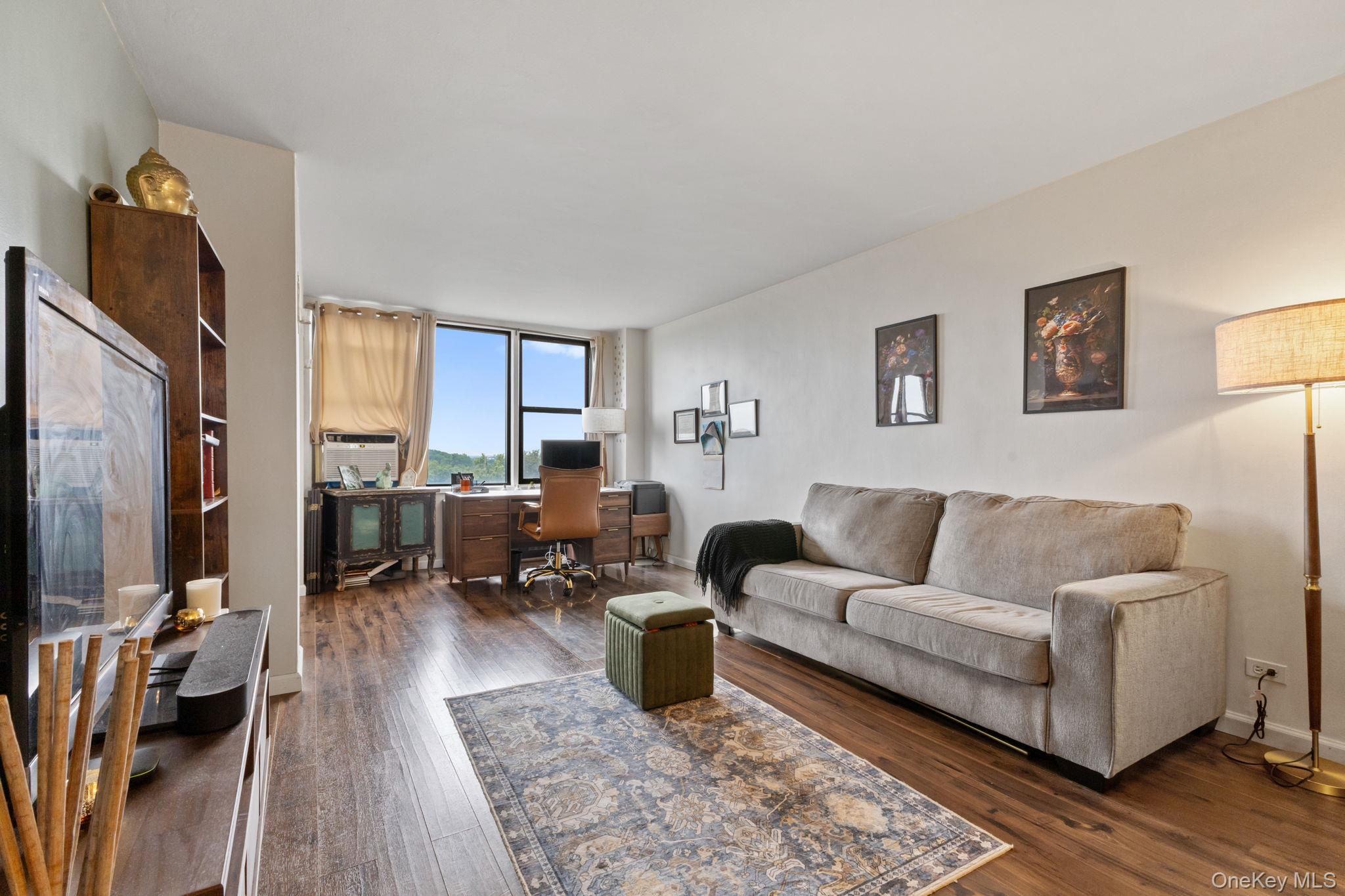3121 Middletown Road, Unit 7L Bronx, NY 10461 - Photo 11 of 23 a living room with furniture wooden floor and a flat screen tv