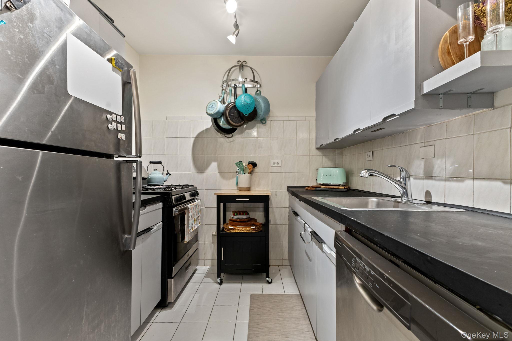 3121 Middletown Road, Unit 7L Bronx, NY 10461 - Photo 8 of 23 a kitchen with a sink stainless steel appliances and cabinets