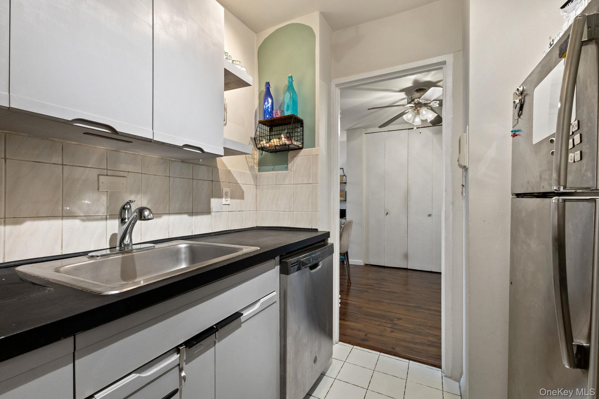 3121 Middletown Road, Unit 7L Bronx, NY 10461 - Photo 9 of 23 a kitchen with a sink and a refrigerator